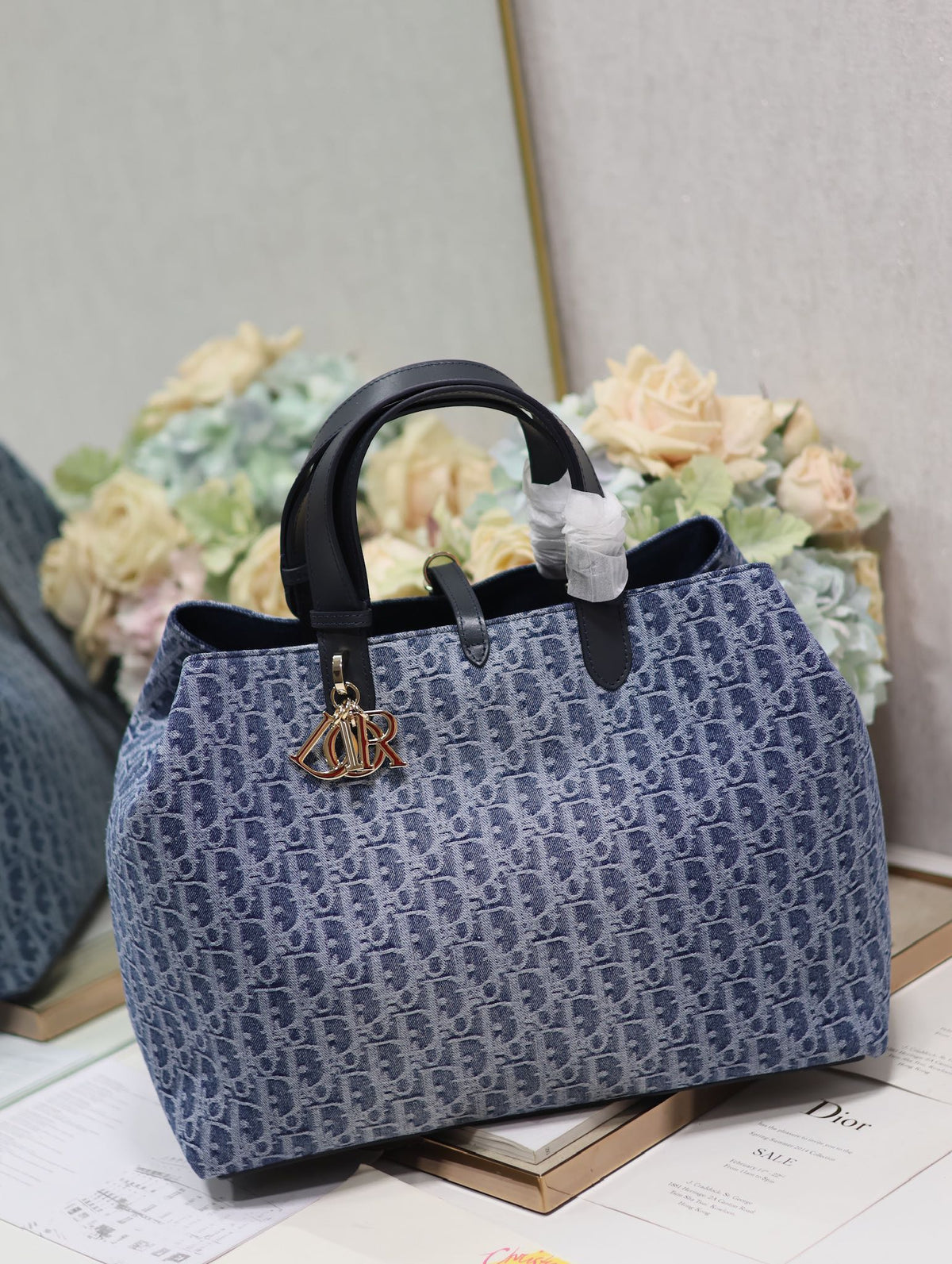 Vintage-Style Blue Monogram Canvas Tote Bag with Black Leather Handles and Gold Charm