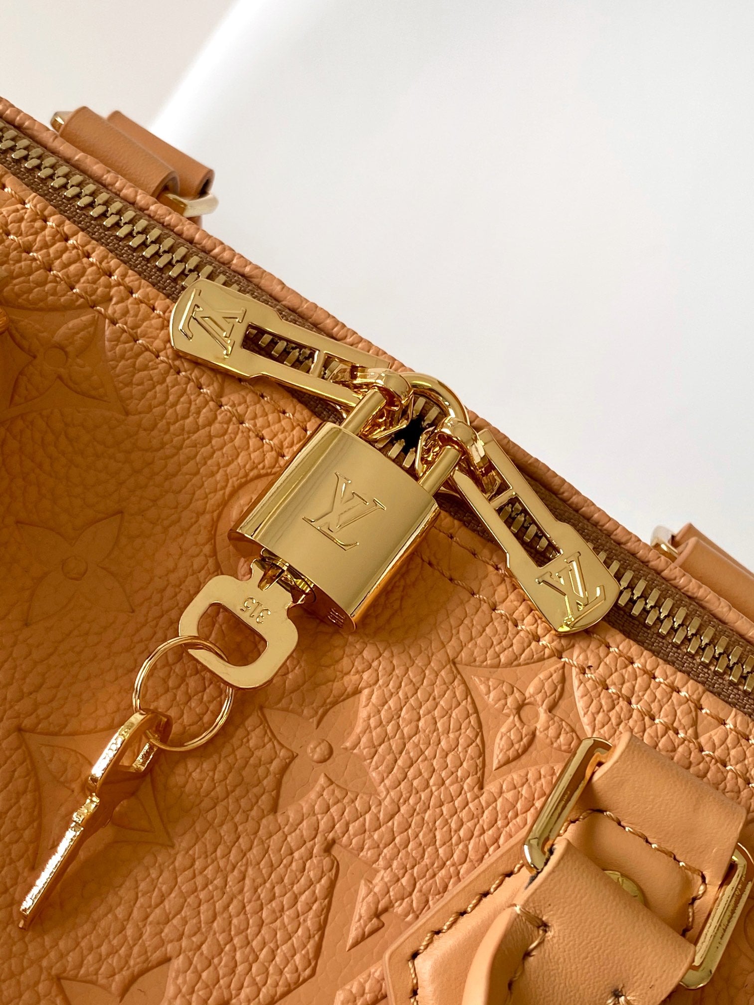 Elegant Tan Monogram Embossed Leather Satchel Bag with Top Handles and Crossbody Strap